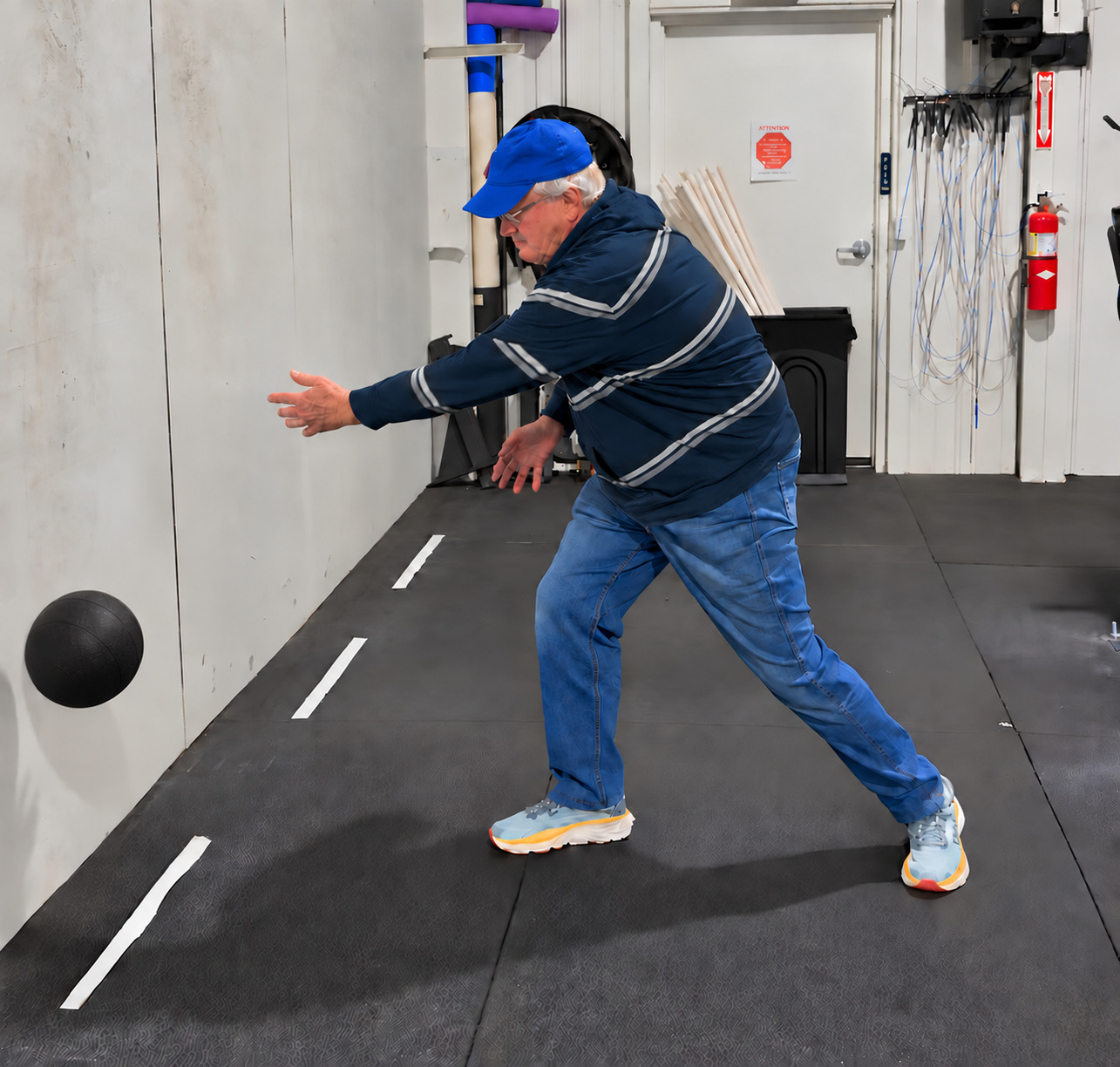 An adult golfer performing a rotational medicine-ball throw